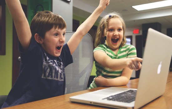 joyful kids looking at computer